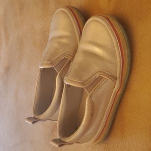 Shiny silver slip ons